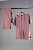 A vintage bespoke made woollen pink two piece suit with flared bottoms.