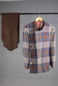 A vintage bespoke made blue, grey and rush woollen tartan three piece suit with brown trousers.