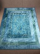 An Indian cotton bedspread embroidered in shades of blue and teal. L.265 W.210 cm.