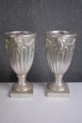 A pair of matching urns decorated with lions heads. H.43cm.(each)