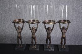 Four outside candleholders. Monkeys supporting glass covers. H.42cm.(each)