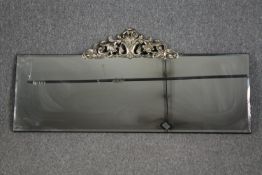 Wall mirror, contemporary bevelled glass with Rococo style cresting. H.54 W.120cm.