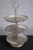 A three tier metal cake stand. H.43 Dia. 23cm.