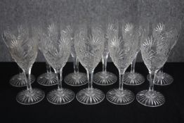 Eleven stemmed wine glasses. Cut crystal with star bases. H.20cm. (each)