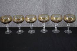 A set of six amber cut to clear stemmed wine glasses with star design. H.16cm. (each)