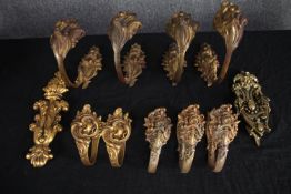A collection of nine baroque style brass curtain (set of four, a pair and three) tie backs, a door