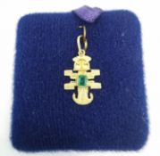 An 18 carat yellow gold pre Columbian style pendant set with an emerald cut emerald (possibly