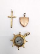 A collection of 9ct gold and rolled gold charms, including a 9ct rose gold shield shape locket, a