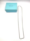 A boxed Tiffany and Co 14 carat 22 inch curb link gold chain with C-sprung clasp. Stamped T&Co, 14K.