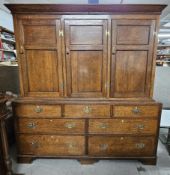 An 18th century Lancashire housekeepers cabinet with panel doors to the upper section enclosing