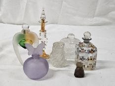 A collection of perfume bottles, including a hand painted 19th century scent bottle, a frosted mauve