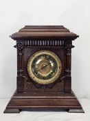 A late 19th century oak cased Ansonia mantel clock. H.38 W.35cm.