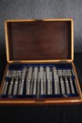 A complete Victorian mahogany canteen of silver plate cutlery for twelve people. The handles with