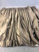 A pair of shot silk gold and bronze fully lined curtains. L.205 W.(top) 300 (bottom) 680cm.