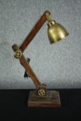 A wooden anglepoise type lamp with a metal shade and fixings. H.77cm.
