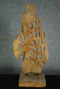 A driftwood abstract sculpture. Honeycombed on a hardwood stand. H.80cm.