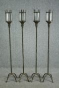 Four late twentieth century floor standing metal garden lanterns with glass shades. Circa 1990. Aged
