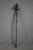 A sword and scabbard. Quite rusted and without a visible maker's mark. With a wooden handle and
