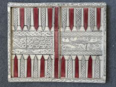A vintage backgammon board in resin on a grip base, moulded to resemble bone and inlay. Decorated