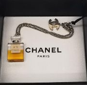 A boxed 2004 Autumn collection Chanel gold Chanel No. 5 charm bracelet. This bracelet features a