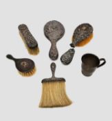 A collection of silver items, including a four piece silver vanity set and child's christening cup