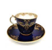 A 19th century hand painted porcelain royal blue and gilded Meissen coffee cup and saucer with