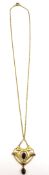 An Art Nouveau design 9 carat yellow gold garnet set pendant and chain. The pendant set with two