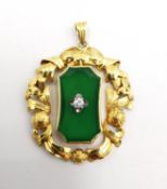 An early 20th century 14 carat yellow gold, jade and diamond pendant. The central jade panel set