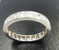 A white metal (tests as platinum) diamond set full eternity ring, set with twenty two round