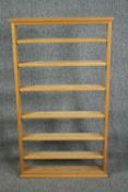 A contemporary light oak wall mounted set of shelves. H.128 W.73 W.12cm.