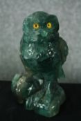 A carved fluorite owl with yellow glass eyes. H.18cm.