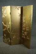 A Japanese three panel screen or room divider with lacquered hand decorated cherry blossom patterns.