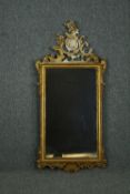 Wall mirror, late 19th century carved giltwood with Rococo scroll cresting. H.132 W.61cm.
