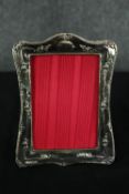 A repousse silver photograph frame bearing English hallmarks. H.19 W.14cm.