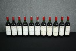 Eleven bottles of Mouton-Cadet Bordeaux. Ten are 1982 and one is 1986. H.30cm. (Each)