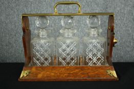 An oak and brass tantalus. H.26 W.40 D.16cm.