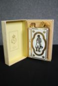 A boxed porcelain flask by Limoges containing Camus Cognac Napoleon brandy. H.25 W.16 D.8cm.