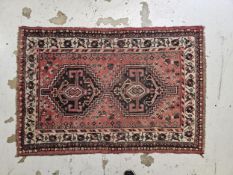 Rug, Persian Karaceh, double lozenge medallion on a burgundy ground. H.160 W.110cm.
