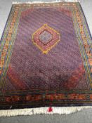 Carpet, south west Persian Abadeh, central lozenge with flowerhead motifs across the field within