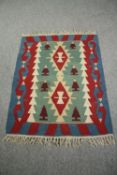 A polychrome Kelim rug. L.117 W.94cm.