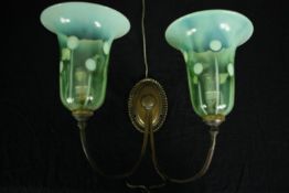 An Art Nouveau brass and art Vaseline opalescent glass twin branch wall sconce. H.29 W.35cm.