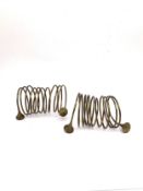 A pair of traditional Naga brass coiled arm bangles with trumpeting ends. L.16 Diameter 8cm