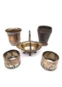 Five pieces of silver and a silver plated Art Deco cup. Two napkin rings by Wilhelm Binder, a