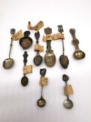 A labelled collection of nine early 20th century souvenir spoons (four silver and white metal) to