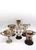 A collection of six silver golfing presentation trophies. Each inscribed with the competition and