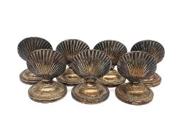 A set of seven early 20th century WMF silver plated scallop shell name place/menu holders. Makers