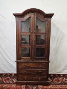 An Eastern teak bookcase cabinet fitted with drawers to the base. H.160 W.78 D.44cm.