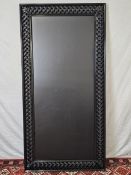 A contemporary carved and lacquered full height mirror. H.200 W.100cm.