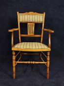 An Edwardian beech armchair.