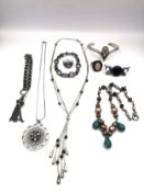 A collection of silver jewellery, including a rose quartz ring, an amethyst and silver ring, a